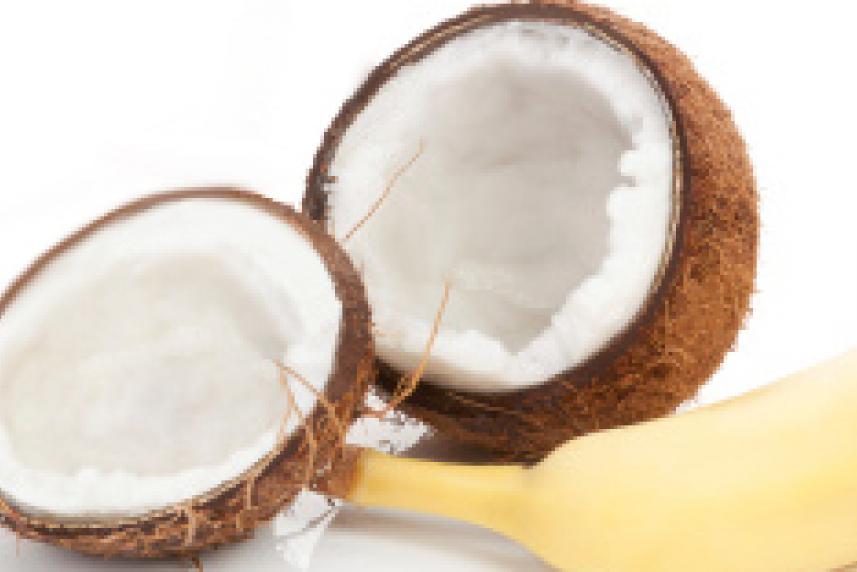 Photo: Opened coconut and banana on white background
