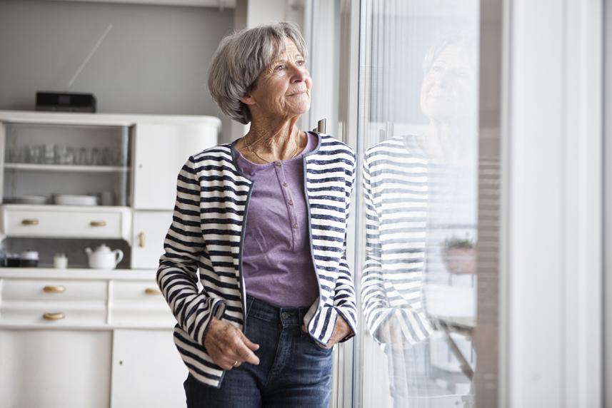 Woman looking out sliding glass door