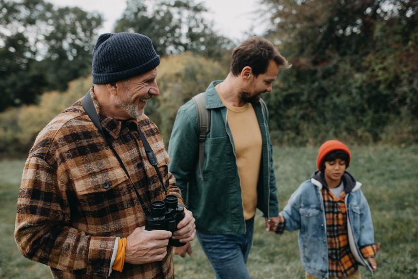 Senior, adult, and child walking