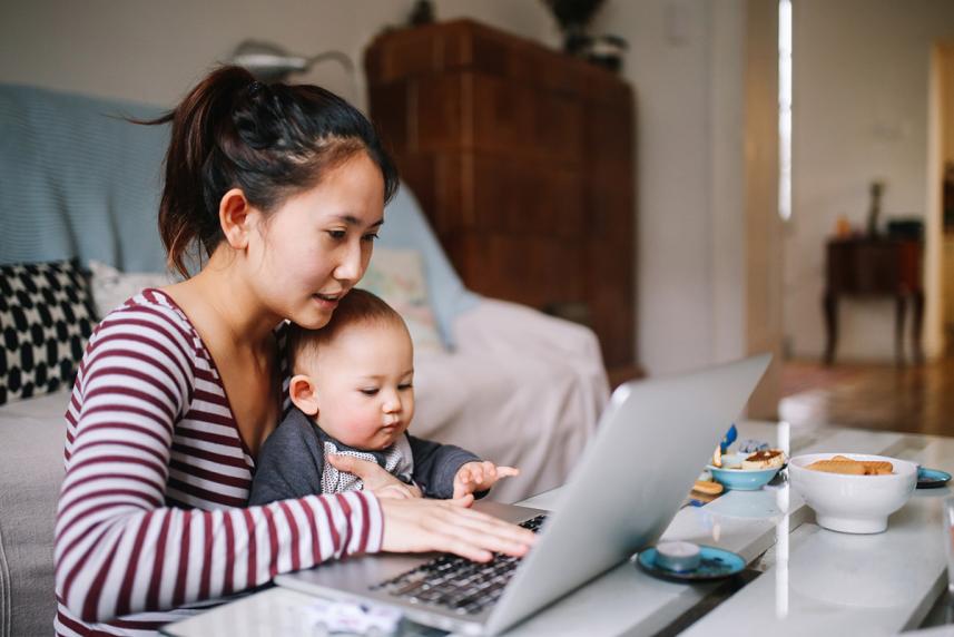 A woman and baby looking at a laptop