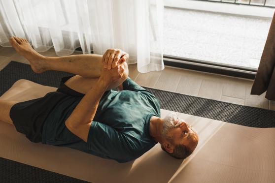 Man stretching at home
